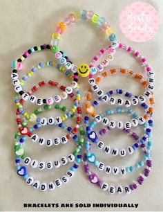 the bracelets are made with beads and letters that spell out happy, joy, happiness