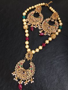 Look best with elegance and class! Set your own vibe! These uniquely designed polki champagne stones and multi beads mala and earrings set are made to glam up your look, going perfect with your outfit! Color : red/green In stock and ready to ship. Traditional Round Kundan Necklace With Stones, Spiritual Chandbali Jewelry Gift, Traditional Round Bridal Necklace With Stones, Chandbali Stone Jewelry Gift, Temple Jewelry Bridal Necklace With Stones For Festivals, Elegant Ruby Jewelry For Puja, Festive Long Gemstone Beads Necklace, Festive Long Gemstone Bead Necklace, Festive Bridal Necklace With Stones