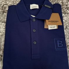 Brand New Burberry Gateforth Polo Shirt For Men. Size Small In Navy Blue Luxury Blue Collared Tops, Designer Navy Collared Top, Luxury Blue Polo Collar Top, Luxury Blue Collared Polo Shirt, Luxury Navy Casual Polo Shirt, Burberry Polo Shirt Men, Designer Blue Cotton Polo Shirt, Luxury Blue Relaxed Fit Polo Shirt, Luxury Navy Polo Shirt