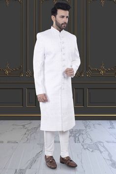 Expertly crafted, the Men's Sherwani in white presents a refined and sophisticated look. With delicate stone and thread embroidery, this Sherwani elevates your style for special occasions. Make a statement with this elegant and timeless piece. Elegant White Formal Kurta, Elegant White Nehru Jacket For Transitional Season, White Unstitched Suit With Naqshi For Wedding, White Unstitched Wedding Suit With Naqshi Details, Elegant White Kurta With Zari Work, Elegant Churidar With Naqshi For Formal Occasions, Elegant White Nehru Jacket With Zari Work, Elegant Traditional Style Kurta, Designer Fitted White Traditional Wear