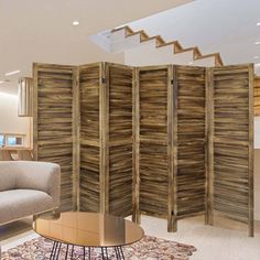 a room divider made out of wooden planks in a living area with a couch and coffee table