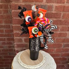 a black vase with candy and decorations on it