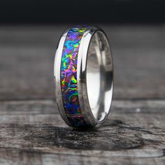 "Dichrolam Titanium Ceramic Ring. This band is created with the Fire Burl Dichrolam material. A rainbow of colors. This ring is like a party on your finger! What is Dichrolam? The Dichroic Optical Core within each lamination is unique in its ability to filter and reflect specific wavelengths of light. This results in a product that will produce dramatic color shifts as the viewing angle changes -- literally changing color before your very eyes. The same optical effects you see in natural opals, butterfly wings, and soap bubbles. // Ring Sizing And Returns // Please double check your ring size before ordering. Please also check if the sizing was done with a comfort fit or standard fit and that the ring listed matches standard or comfort fit. If you don't know your ring size please contact m Formal Multicolor Opal Ring, Modern Round Rainbow Jewelry, Modern Rainbow Round Jewelry, Multicolor Polished Finish Rings For Gift, Multicolor Polished Rings Perfect As Gift, Multicolor Polished Rings As A Gift, Multicolor Polished Rings For Gifts, Round Multicolor Jewelry For Promise, Multicolor Fusion Rings For Anniversary