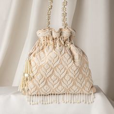 "Beautiful Beige Satin Pearl Embroidered Wedding Handbag for Bridesmaid | Evening Designer Drawstring Woman Purse | Indian Handmade Potli Bag Package Contents: 1 Size: 10\" x 8\" Designed with the heart, this beautiful Potli or batawa bag are eye catchy and made of premium material. Key Features: Embroidery art work.  This potli is good match with both Indian and western outfits and are superb for wedding and festive parties. This would be best complement to your designer saree, lenhga or any other kind of dress. This is the combination of traditional and modern embroidery work. This is enough to keep your accessories and all needed essentials and it can be a best gift for any woman." Potli Purse, Saree Accessories, Woman Purse, Wedding Handbag, Potli Bag, Potli Bags, Embroidered Wedding, Wedding Bag, Accessories Bags Purses