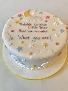 a white cake with stars and moon on it that says twinkle little star how we wonder what you are