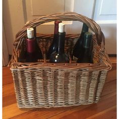 three bottles of wine in a wicker basket