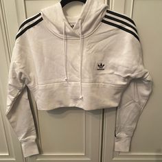 Brand New Never Worn Adidas Crop Sweatshirt. What With Infamous Black Adidas Stripes. Size M. White Cropped Cotton Sweatshirt, White Fitted Top With Ribbed Cuffs, Adidas Cotton Sportswear Tops, White Cropped Sweatshirt For Winter, White Fitted Sweatshirt For Spring, Fitted White Sweatshirt For Spring, Spring White Fitted Sweatshirt, White Athleisure Hoodie With Three Stripes Branding, White Winter Sweatshirt With Three Stripes Branding