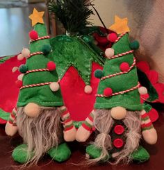 three christmas gnomes with green and red decorations