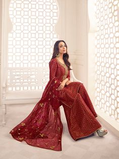 This Malaika Arora Maroon Zari Woven Yoke Design Embroidered Straight Kurta set features true craftsmanship in a luxurious silk blend design. Embellished with intricate Zari, this sharara is perfect for ethnic events and winter parties. Ready-to-wear, it features a round neck and three-quarter sleeves, with side slits for extra comfort. Grandeur and majestic artwork is attributed to this exquisite creation by Malaika Arora. TOP: Silk Blend(Brocade), TOP INNER: Cotton, BOTTOM: Silk Blend(Brocade) Anarkali Palazzo Set With Intricate Embroidery, Festive Unstitched Anarkali Set With Resham Embroidery, Transitional Straight Kurta Palazzo Set With Intricate Embroidery, Festive Floor-length Kurta With Intricate Embroidery, Festive Anarkali Kurta With Intricate Embroidery, Designer Sharara With Intricate Embroidery And Straight Kurta, Designer Bollywood Sharara With Resham Embroidery, Festive Unstitched Anarkali Set With Intricate Embroidery, Designer Palazzo Set With Intricate Embroidery For Eid