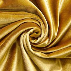 a close up shot of a gold colored fabric that is very soft and shiny in the wind