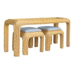 two stools and a table made out of wicker with blue cushions on them