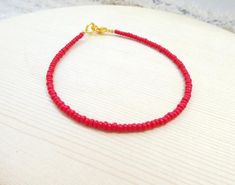 These trendy delicate bracelet or anklet are simple and modern. They close with a lobster clasp. They are made with opaque red seed bead.  ❤ SIZESThis item comes in several sizes, kindly choose at checkout. The easiest way to find out which length suits you best is to measure a bracelet you already own, from one end to the next, including clasp. You can use a ruler or any measuring device at home. The standard size bracelet for an average woman is 7”. For a child, perhaps a 6” would be appropria Minimalist Red Beaded Bracelets For Everyday, Red Minimalist Beaded Bracelets For Everyday, Minimalist Red Beaded Bracelet With Tiny Beads, Dainty Red Beaded Bracelets With Tiny Beads, Average Woman, Red Bracelet, Bracelet Minimalist, Bracelet Simple, Seed Bead Bracelet