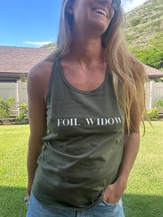 Let the wind feel the Foil Widow racer back tank! This cotton tank is designed to keep you cool, looking stylish, and feeling awesome. Perfect for a beach run or just chilling in the sun! 100% cotton graphic printed racer back tank top Casual Racerback Tank Top With Letter Print, Athleisure Cotton Tank Top With Graphic Print, Casual Cotton Racerback Tank Top, Summer Workout Cotton Tank Top, Cotton Letter Print Tank Top Athleisure, Trendy Racerback Cotton Tank Top, Trendy Cotton Racerback Tank Top, Summer Racerback Tank Top With Letter Print, Moisture-wicking Cotton Tank Top