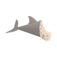 a shark shaped container with popcorn in it's mouth, on a white background