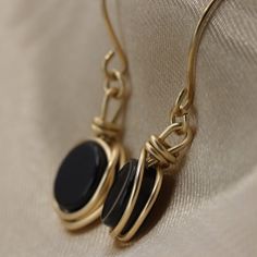 There is nothing ordinary about this wrap earrings. Set with a beautiful Black Onyx that goes well with any outfit. Most recommended as a set with our black onyx ring and necklace :) Necklace here: https://www.etsy.com/il-en/listing/949968751/black-onyx-knot-necklace-handmade?ga_search_query=black%2Bonyx&ref=shop_items_search_2&pro=1&frs=1 Ring here: https://www.etsy.com/il-en/listing/768189894/black-onyx-knot-ring-handmade-ring-onyx?ga_search_query=black%2Bonyx&ref=shop_items_se Elegant Adjustable Wire Wrap Earrings, 14k Gold Filled Wire Wrapped Earrings For Gift, Black Minimalist Jewelry With Ear Wire, Elegant Wire Wrapped Wrap Earrings In Brass, Minimalist Handmade Black Earrings, Elegant Wire Dangle Wrap Earrings, Elegant Wire Wrap Dangle Earrings, Elegant Gold Wire Wrapped Wrap Earrings, Minimalist Wire Wrapped Round Earrings