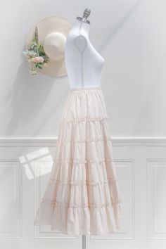 An elegant-yet-versatile skirt perfect for mixing-and-matching, the 100% cotton Antoinette skirt in cream features tiers accented with ruffles, a comfortable elastic waistline, and flowy silhouette made for twirling! . Details: S: Waist 26"-32", Length 35" M: Waist 28"-34", Length 35.5" L: Waist 30"-36", Length 36" Elastic Waistline Material: 100% Cotton Unlined Care: Hand Wash Cold / Hang Dry Imported Ships in 1 to 2 Business Days Free US Shipping on Orders over $100 Cottagecore Skirt Outfit, Outfit Basics, Cottagecore Skirt, Cream Skirt, Cottagecore Outfits, Peasant Skirt, Cotton Midi Skirt, French Girl Style, Skirt Outfit