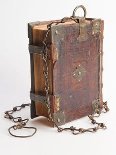 an old book is chained to a chain