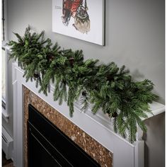 a christmas mantle with pine cones and evergreen branches