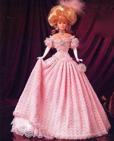 a barbie doll wearing a pink dress and hat