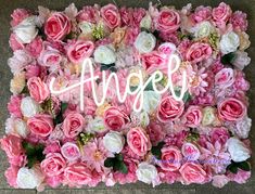 an arrangement of pink and white flowers with the word angel spelled in large letters above it