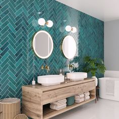 a bathroom with two sinks and mirrors in front of a blue tiled backsplash