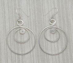 "Handmade Sterling Silver Large Spiral Hoop Dangle Earrings, Shinny finish, Materialistic Simple Lines Elegant earrings Length (without dangle): 1.95\" / 5cm Width: 1.45\" / 3.7cm Metal Purity: 95% Silver (Purer than 925 Sterling Silver) To browse some more of our silver jewelry collection you can click on the following links: https://www.etsy.com/shop/SilverShapes Earrings: https://www.etsy.com/shop/SilverShapes?section_id=14809462&ref=shopsection_leftnav_1 Rings: https://www.etsy.com/shop/ Hand Symbols, Hoop Dangle Earrings, Luxurious Jewelry, Luxurious Fashion, Hoops Earrings, Hello World, Earrings Minimalist, Simple Lines, Elegant Earrings