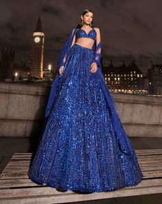 This navy lehenga set features all over tonal sequin embroidery in a geometric pattern. The ensemble is paired with a strappy blouse with tassels at the waist and a matching net dupatta.From Seema Gujral's For the love of London collection. DELIVERY TIMEPlease allow 8-12 weeks for your outfit to arrive. FABRIC DETAILSNet Professional cleaning only. Dusty Blue Lehenga, Blue Sequined Sets For Reception, Blue Sequined Sharara For Reception, Blue Sharara With Sequins For Reception, Glamorous Blue Embellished Sets, Blue Sequined Party Wear Sets, Blue Sequined Party Wear Choli, Blue Sequined Choli For Reception, Designer Blue Sequined Sharara