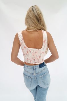 Flaunt your sweet and sassy side with our Talula Floral Tank! This corset-style tank features a beautiful floral print that adds a touch of femininity to your look. Perfect for a playful and fun-loving fashionista. Featuring an elastic back and side zipper closure. Spring Tank Top With Square Neck, Summer Tank Top With Square Neck For Spring, Pink Sleeveless Summer Corset, Pink Sleeveless Corset For Summer, Feminine Spring Tank Top With Tank Straps, Feminine Square Neck Tank Top For Spring, Fitted Floral Print Sleeveless Crop Top, Chic Sleeveless Tank Top With Boned Bodice, Spring Square Neck Fitted Corset