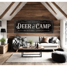 deer and camp hunting lodge sign mounted on the wall above a couch in a living room