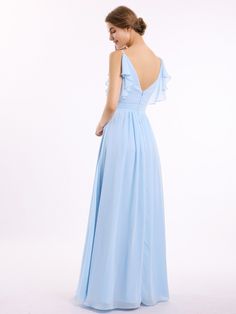 a woman in a blue dress is looking down at the back of her dress,