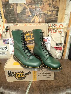 These Green 10 hole Dr Martens boots are truly vintage. They are s pair from the 1990s . They are of the highest quality. Made it England stock. They are an ex display pair and have some markings on the upper. They are a UK size 6, European 39, ladies USA 8 High-top Green Combat Boots For Fall, Green High-top Combat Boots For Fall, Vintage Steel Toe Boots For Fall, Vintage Moto Boots For Streetwear With Round Toe, Vintage High-top Moto Boots For Streetwear, Vintage Boots For Winter Streetwear, Vintage Steel Toe Lace-up Combat Boots, Vintage Steel Toe Ankle Boots, Retro Winter Boots For Streetwear