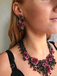 Elegant chandelier drop earrings in black and garnet flowers with green leaves. The flowers are hand painted resin and the red rose is a handmade polymer clay flower. The top part is hand beaded with tiny cluster of small flowers which drops to a central flower cluster, then finished with a fringe of jet black glass beads on the bottom. Ever so pretty with anything in black. This is a quality piece of jewelry that will last a life time. Created by designer Colleen Toland who has been creating he Chandelier Flower, Beaded Fabric, Painted Resin, Garnet Red, Flower Cluster, Glass Cylinder, Mat Black, Clay Flower, Red Jewelry