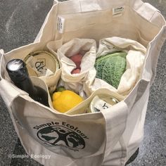 a grocery bag full of groceries sitting on the ground