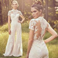 two women standing in the woods with their back to the camera, one wearing a wedding dress