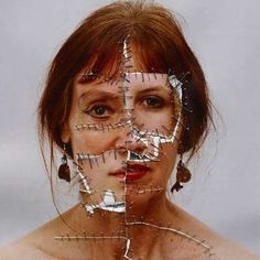 a woman with her face taped up to the side and lines drawn on it's face