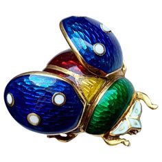 This 18 Kt gold and enamel brooch depicting a ladybug with open wings was handcrafted by a talented Italian goldsmith. Symbol of good luck, the ladybug is said to give blessings to those she encounters. Master in the art of metamorphosis, she transforms from a hideous larva to a beautiful insect adorned with bright colors. This totem animal is a powerful ally to make important changes in your life and go through your life’s journey with ease. Let’s discover its encouraging message: Believe in yo Yellow Gold Enamel Brooches Hallmarked, Unique Yellow Gold Enamel Brooch, Yellow Gold Enamel Brooches For Gifts, Yellow Gold Enamel Pin Collectible, Hallmarked Enamel Brooches As Gifts, Hallmarked Enamel Brooches For Gifts, Gift Enamel Brooches Hallmarked, Multicolor Enamel Collectible Pin, Unique Collectible Enamel Pin