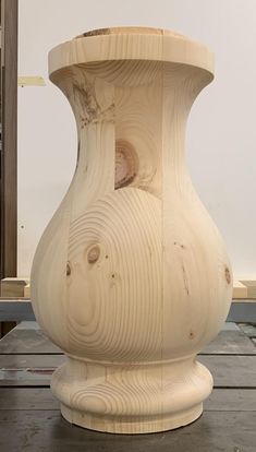 a large wooden vase sitting on top of a table