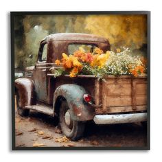 an old truck with flowers in the back