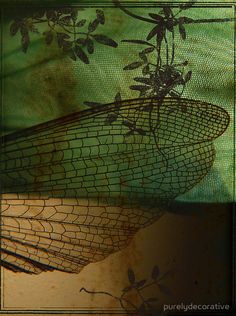 an image of a wire basket with leaves and branches on the outside, in front of a green background