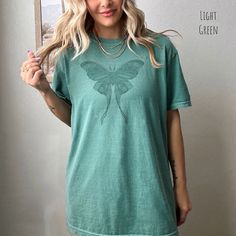 "🌿 We have curated a Shades of Moths collection that resonates with the wanderer's soul. The mystical aura surrounding these moths evokes a sense of wonder and curiosity, inviting you to embrace the magic of life's simple pleasures. Let your inner bohemian spirit shine through as you don these tees, perfect for strolls through wildflower meadows or cozy evenings by the fire.  Welcome to our enchanting world of \"Shades of Moths T-Shirt\" collection! 🦋 Indulge in the mesmerizing allure of natur Butterfly Clothing, Mystical Fairy, Moth Shirt, Butterfly Clothes, Fairycore Aesthetic, Comfort Colors Tshirt, Luna Moth, Comfort Colors Tee, Flower Shirt