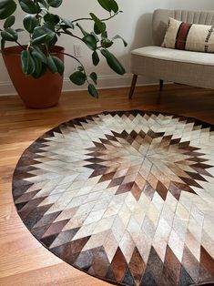 a living room with wooden floors and a round rug on the floor next to a couch