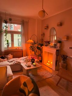 a living room filled with furniture and a fire place in front of a large window