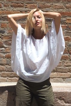 Flutter free in this tasteful gauze cotton crop top. The Petal Top is a true blouse, not a poncho. A light 3/4 sleeve covers your arms from the sun while still providing breathability and flexibility. This may become your favorite comfort top to throw on with anything! Modest, yet feels like wearing nothing. Perfect for travel. Made of 100% breathable woven cotton.Fits XS-MBust up to 44" Waist up to 44" Length 22.5" Tip: White is best with a nude bra. Undyed and colors are less transparent. Mode Nude Bra, Cotton Crop Top, Comfortable Tops, Cool Fabric, Woven Cotton, Cotton Tops, Natural Cotton, Womens Clothing Tops, Clothes For Sale