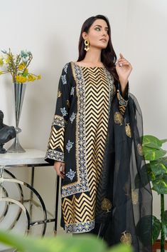 SKU: 1903 Price for Shirt and Pants A monochrome print accentuated with both gold and silver block print. This luxury silk shirt is beautiful for any festivity. Dupatta as is can be added. Shirt length 38. Model is wearing S Gold Embroidered Palazzo Set For Festivals, Gold Palazzo Set For Eid Festivities, Formal Anarkali Dupatta With Printed Motifs, Festive Gold Palazzo Set For Eid, Gold Dabka Chanderi Palazzo Set, Gold Chanderi Palazzo Set With Dabka Details, Traditional Gold Palazzo Set With Gold Embroidery, Elegant Palazzo Set With Printed Motifs For Party, Festive Gold Palazzo Set With Gold Embroidery