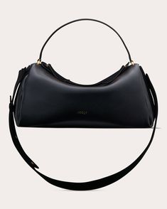 Crafted from genuine calf leather, the Scorpius bag shows off a sleek, sculptural silhouette detailed with gold-tone hardware and a concealed zip closure. Uniquely adjustable and rotatable, the strap can be worn on the shoulder, across the body, or tucked into the base's inlet for clutch-style carrying.Adjustable rotatable strapTop handleGold-tone hardwareConcealed zip closureOuter: 100% calf leatherLining: 100% suede leatherSpot cleanImported Measurements Width: 15.75in Height: 7.87in Depth: 7.