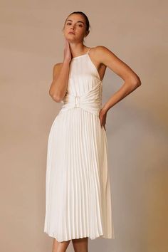 Elevate your formal attire with the Marilyn White Pleated Midi Dress. Featuring an apron neck, modern corset waist, and back tie, this plisse dress adds allure to any event. With its sophisticated design and charming details, you'll feel confident and polished. Perfect for both formal events and cocktail parties. Satin Dress With Pleated Back For Date Night, Fitted Bridesmaid Midi Dress With Tie Back, Chic Midi Dress For Banquets, Dressy Fitted Midi Dress With Tie Back, Formal Pleated Evening Dress, Dressy Pleated Evening Dress For Formal Events, Spring Satin Midi Dress With Pleated Back, Summer Pleated Banquet Dresses, Chic Maxi Length Banquet Dress