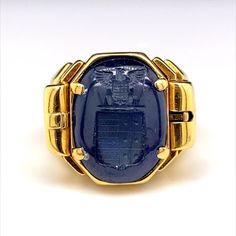 A truly remarkable reversible sapphire carved signet ring in 18 karat yellow gold, circa 1940. This unusual and ingeniously crafted ring comprises of a deep blue cabochon sapphire, engraved with a seal to one side with a smooth polished cabochon dome to the other. The wearer can choose to either wear the sapphire on its smooth polished dome or by using its clever integrated side release mechanism to flip over the sapphire to reveal its seal engraving. This ring really has an impressive wow facto Luxury Sapphire Signet Ring As Promise Ring, Sapphire Signet Ring, Gold Signet Ring, Signet Ring, Deep Blue, Antique Gold, Jewelry Rings, Sapphire, Bangles