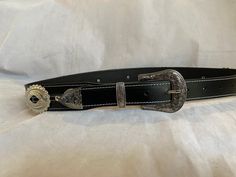 100% Genuine Leather Australian Made  This is Black leather western belt with small and big oval conchos with a Western three piece silver buckle set  , the belt is 38mm (1 1/2") and tapers down to 30mm where it buckles up , made to your requested waist size, waist size is from the buckle end of the leather to the middle hole then you will have three holes bigger and three holes smaller, just add your waist size in message to seller or message me , happy to help in custom work Western Concho Belt Buckles For Western-themed Events, Western Adjustable Belt Buckles For Rodeo, Classic Concho Belt For Western-themed Events, Western Style Adjustable Belt Buckles For Rodeo, Western Concho Belts For Ranch, Leather Concho Belt Buckles For Rodeo, Black Concho Belt Buckles For Ranch, Black Western Belt Buckles With Silver Buckle, Western Black Belt Buckles With Silver Detail