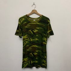 Vintage Army Camo Tshirt Size on tag : fits Small Measurement  Armpit : 17" Shoulder to bottom : 28" *Good used condition. *No holes or stains. *Overall condition is 8/10. Military Style Crew Neck T-shirt For Streetwear, Camouflage Graphic Print Crew Neck T-shirt, Military Style Cotton T-shirt With Graphic Print, Casual Camouflage Short Sleeve T-shirt, Summer Camouflage Cotton T-shirt, Military Crew Neck T-shirt For Streetwear, Green Military Style T-shirt With Crew Neck, Green Military Crew Neck T-shirt, Military Crew Neck T-shirt