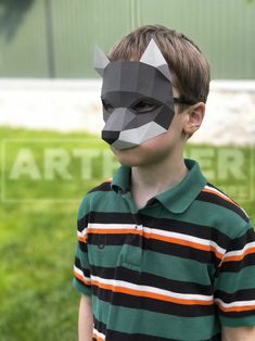 a young boy wearing a paper animal mask